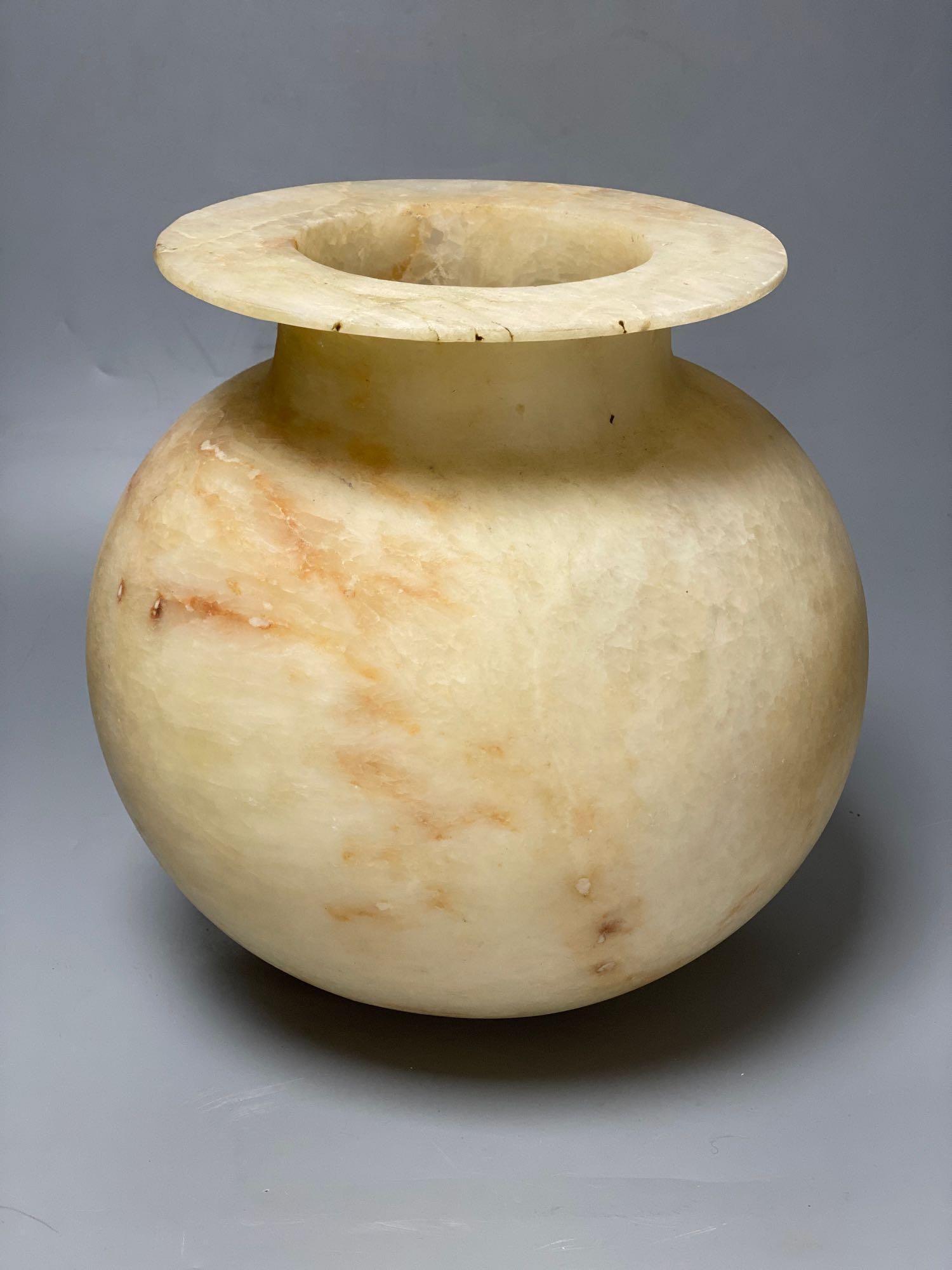 An alabaster bowl with everted rim, height 27cm